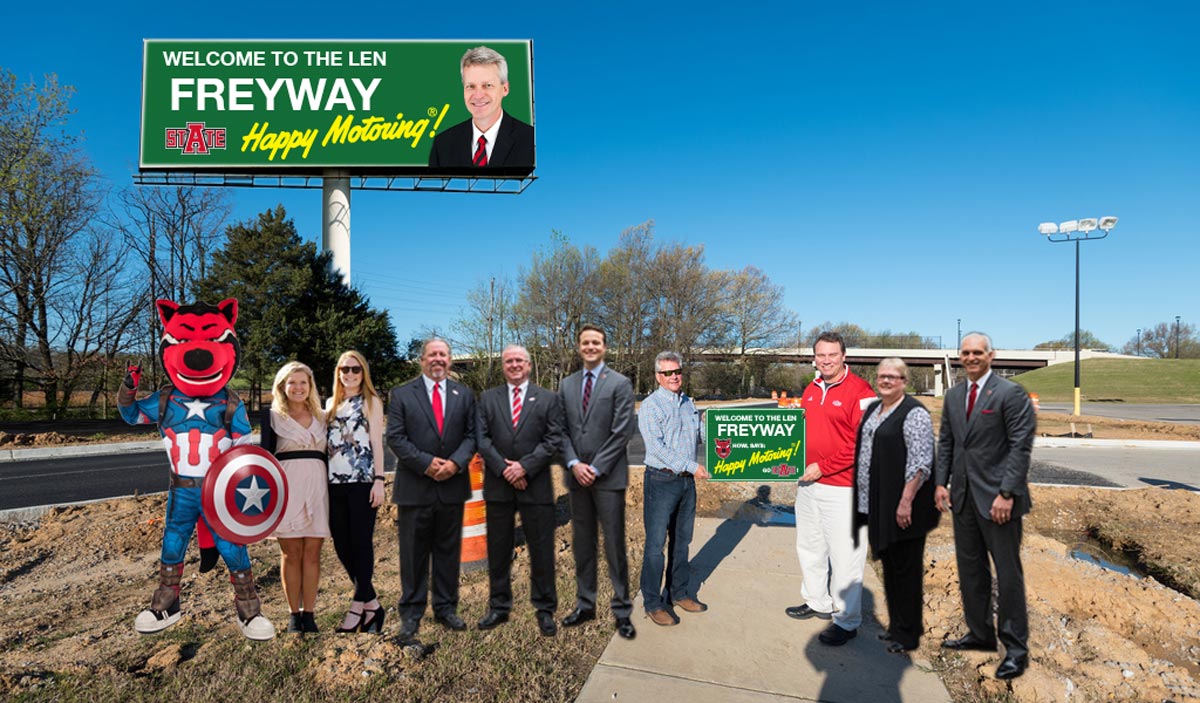 A photoshopped photo of university officials and community members at the entrance to the new road.