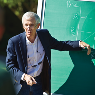 Professor at a chalkboard