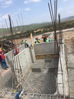 Construction workers at the Arkansas State University Campus Queretaro site in Mexico install concrete footings.