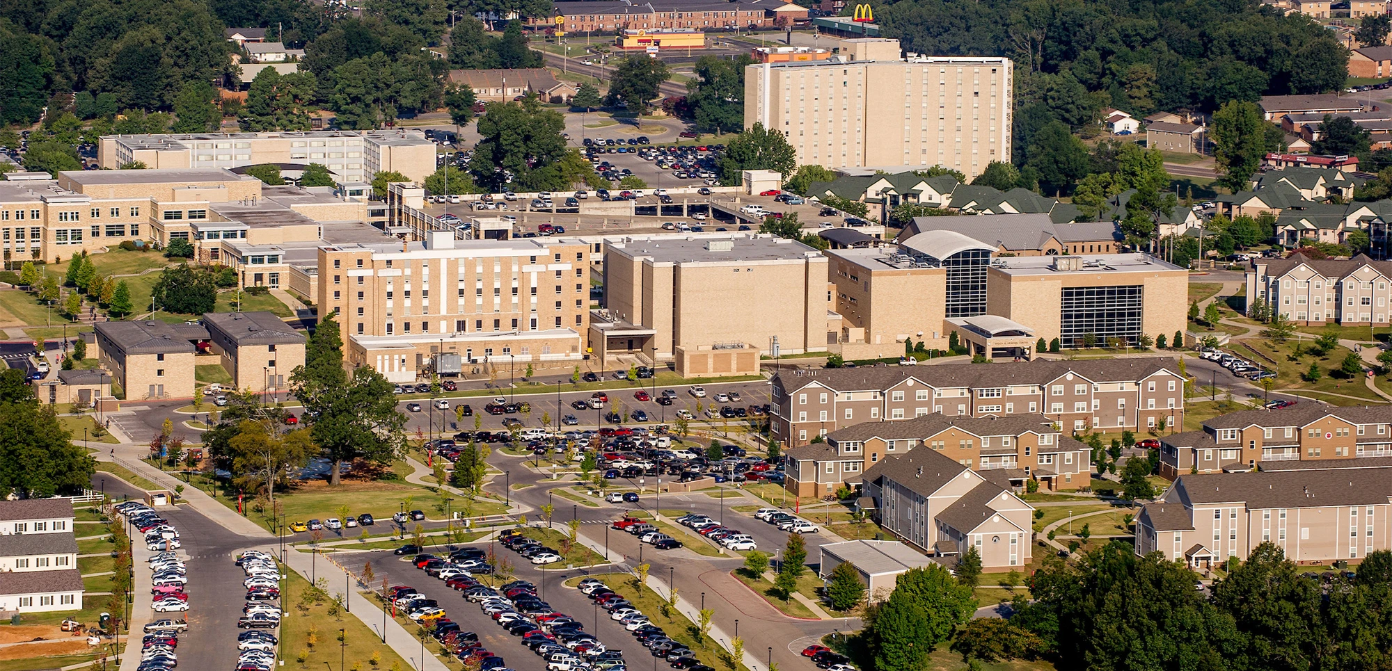 aerial photo of parking lots and campus buildings