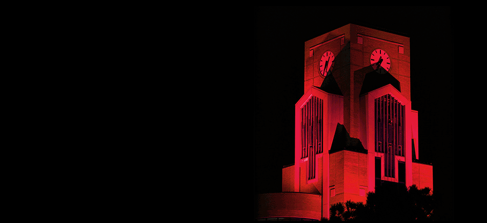 A-State clock tower glowing Red, White and Blue