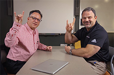 Dr. Jim Washam and Dr. Todd Shields with their Wolves Up hand gesture.