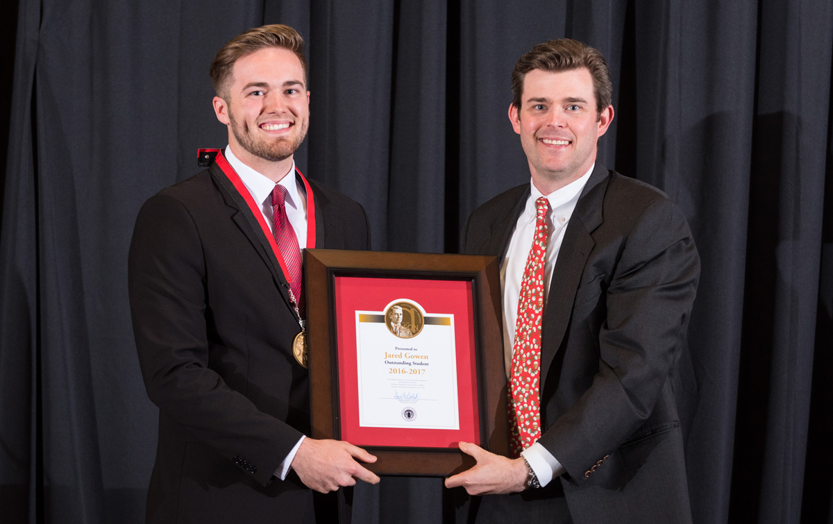 Jared Gowen accepts the 131st Wilson Award from Perry Wilson