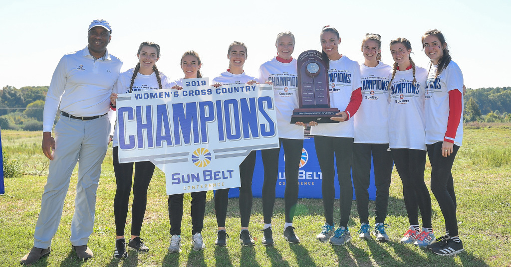 A-State's XC team holding the trophy