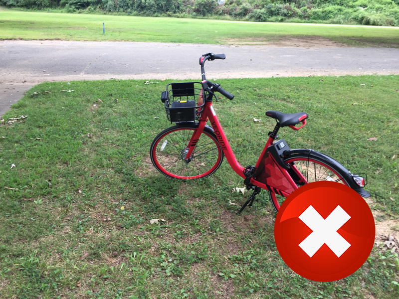 A bike locked to a light pole