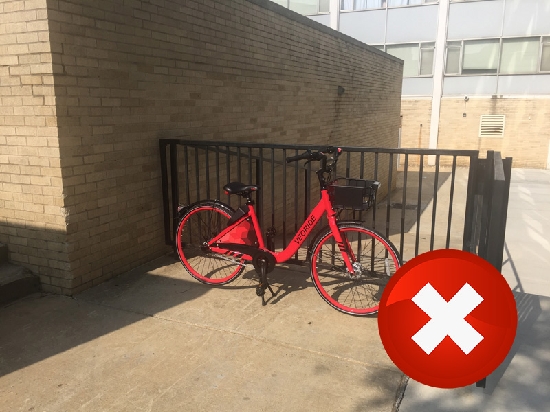 A bike locked to a handrail