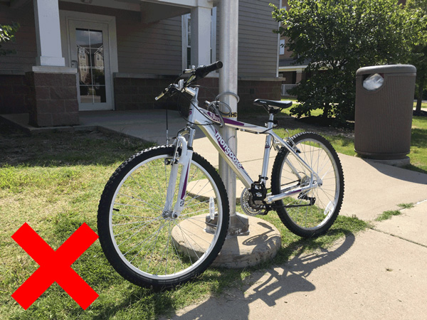 A bike locked to a light pole