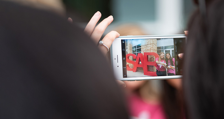 Students taking pictures at a SAB event