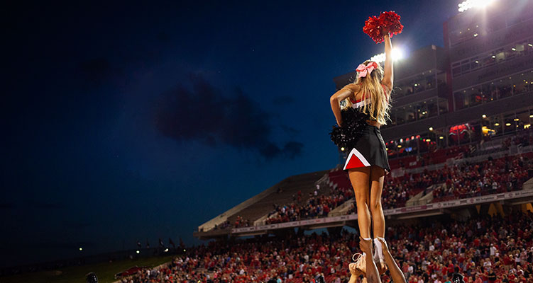 A cheerleader at an A-State football game