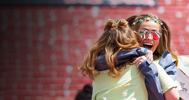 Two sorority members hugging on Bid Day