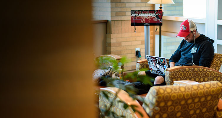 A student studying on his laptop in the union