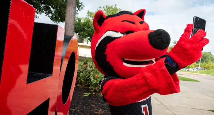 Howl taking a selfie by the HOWL statue