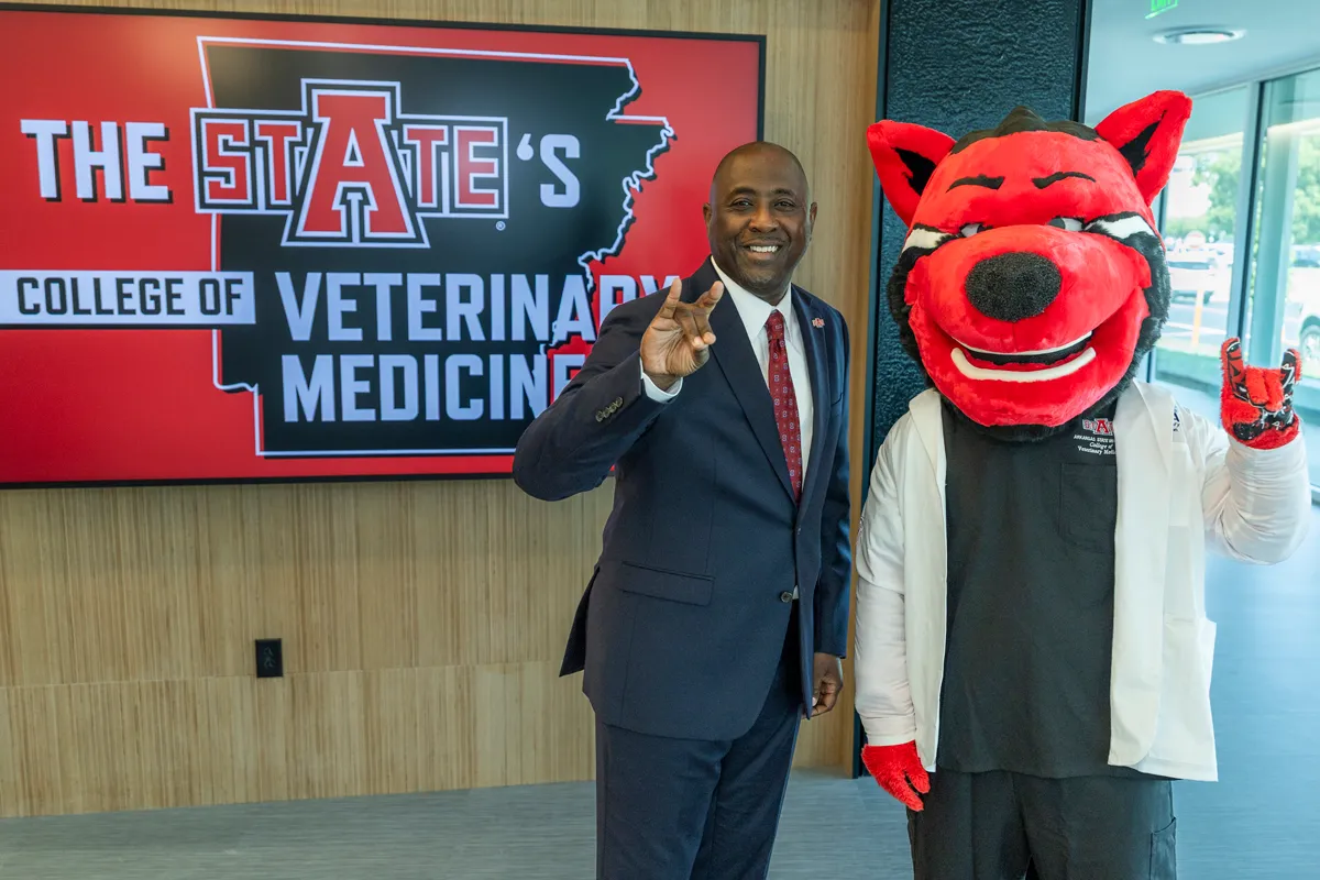 Dr. White poses for a photo with HOWL at the CVM ribbon-cutting ceremony