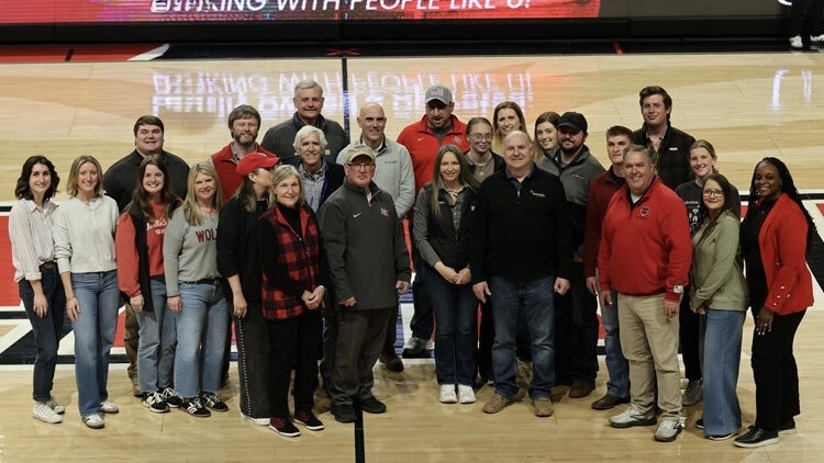 Representatives from Farm Credit Mid-America joined Arkansas State University leaders and College of Agriculture faculty and students on the court at First National Bank Arena to celebrate a $125,000 commitment supporting Beyond the Classroom Experiences in the college.