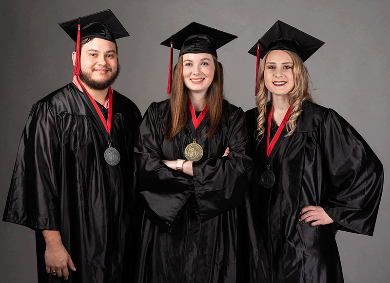 An honors graduate holding a medal