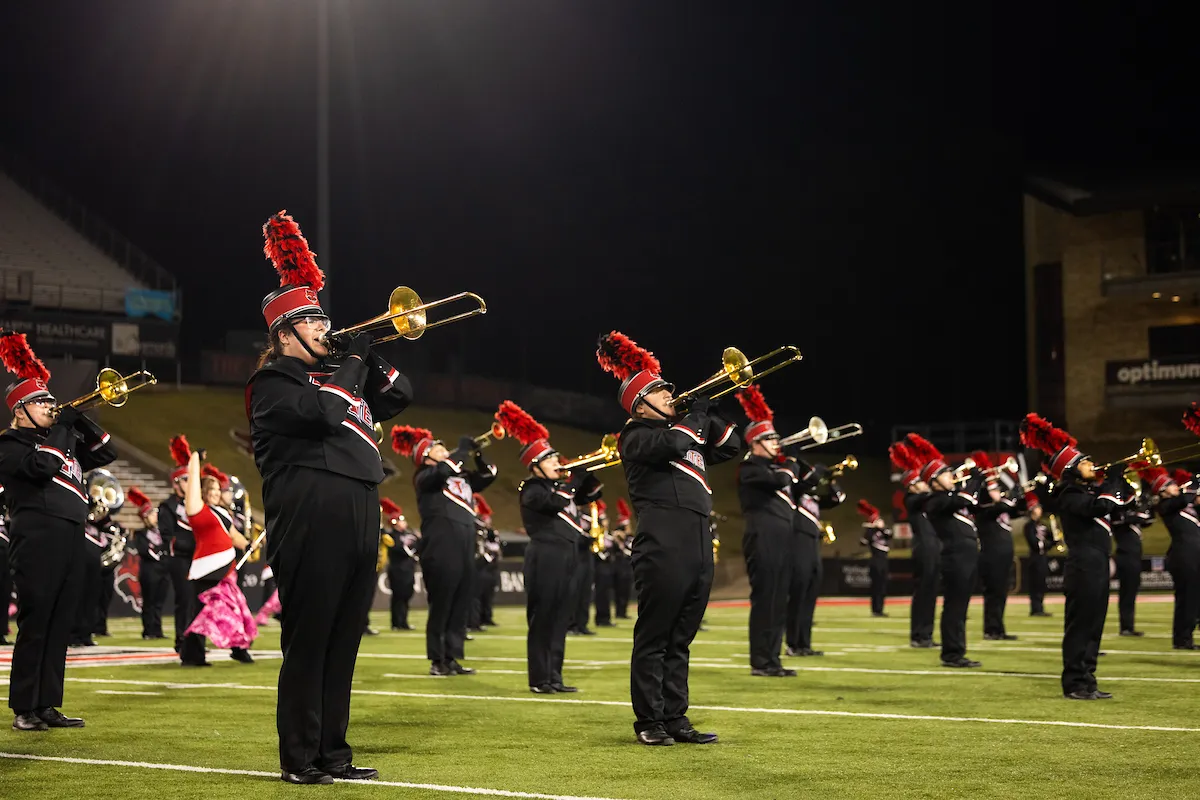 Members of the brass section perform at a football game