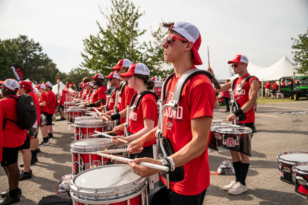 The drumline performs at the tailgate area