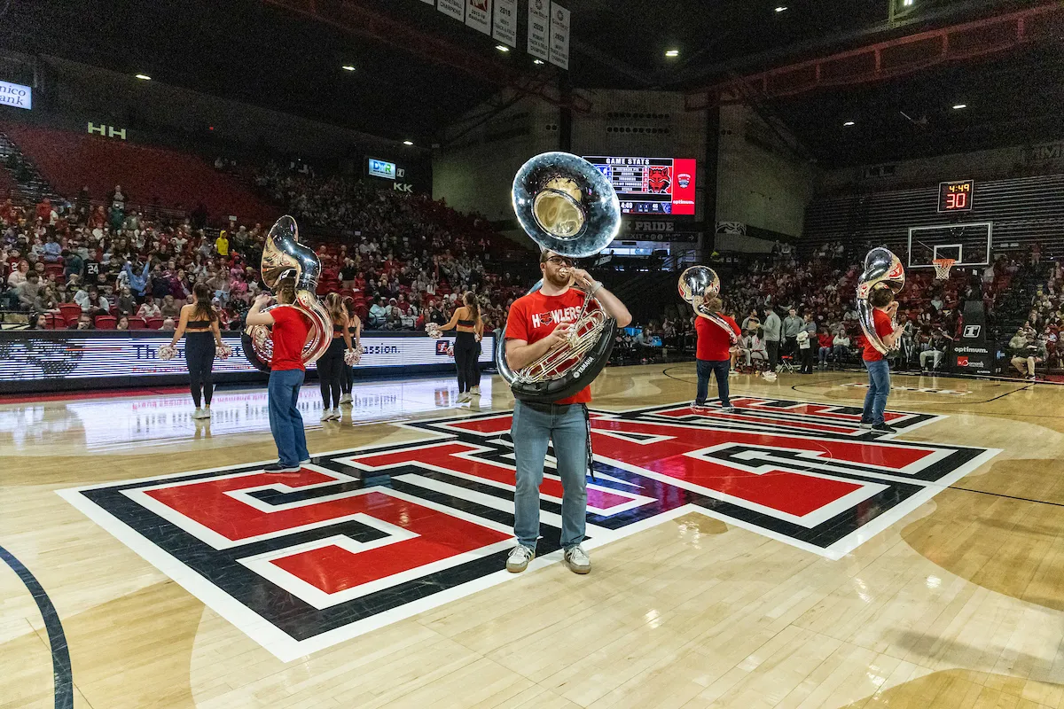 The howler pep band performs at a basketball game