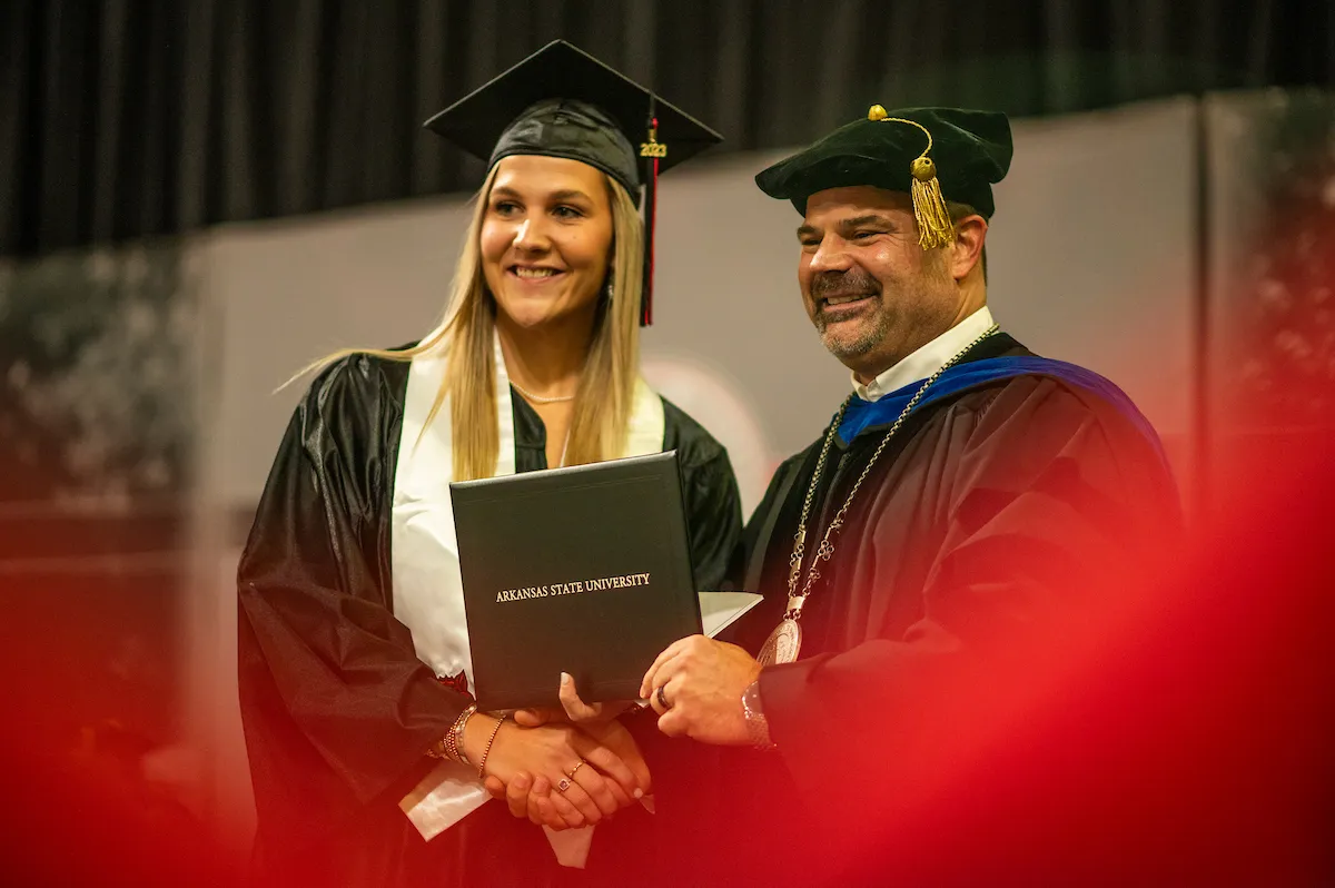 A student receives a diploma at commencement