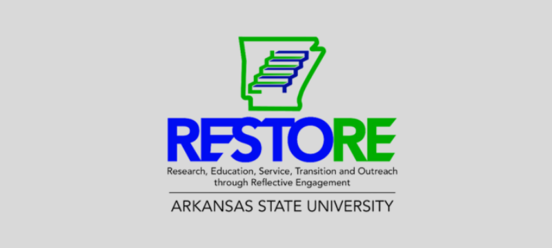Nine new RESTORE Hub employees grouped together on a light gray background
