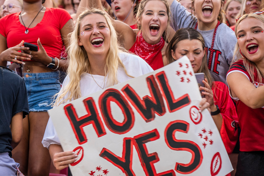 A student holding a Howl Yes sign.