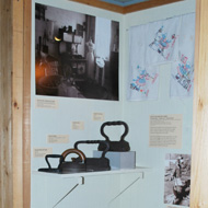 exhibit wall along with antique irons in the Living Off The Land exhibit