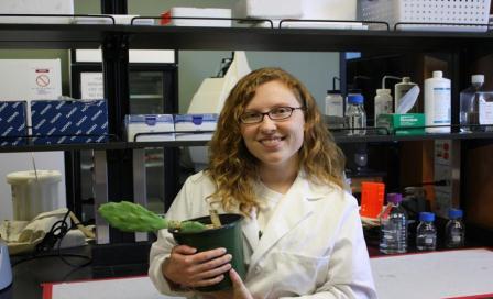 Anastasia Woodard with a cactus in the lab