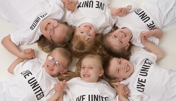 Kids wearing a Live United shirt