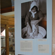 photo of woman scrubbing clothes with scrub board in the Living Off The Land exhibit