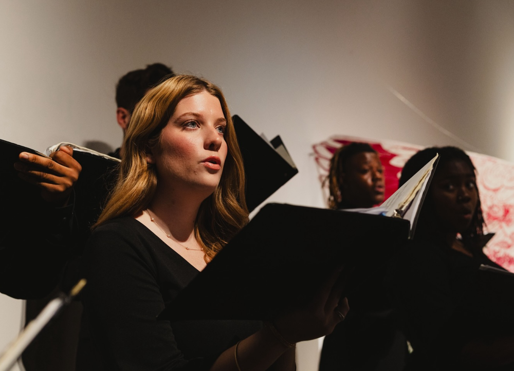 Choir members singing at the Bradbury Art Museum.