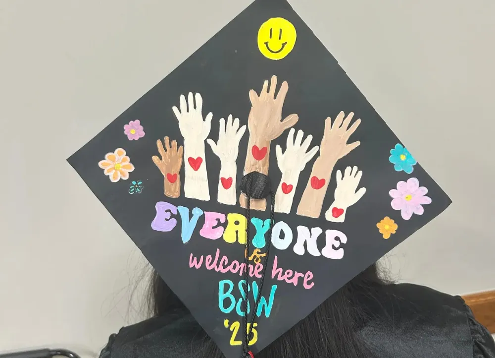 Graduation hat that ways "everyone is welcome here" on a social worker graduation hat