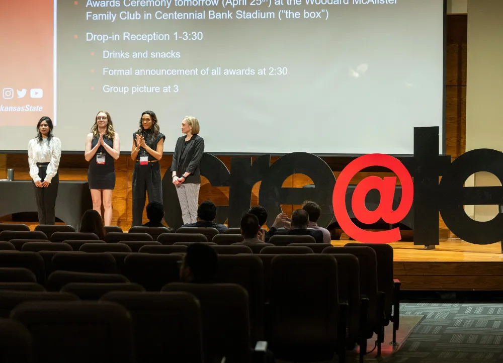2025 create at astate opening event with students on stage giving presentation.