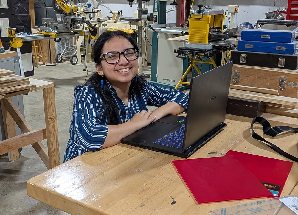 Student working at laptop in the Garage.