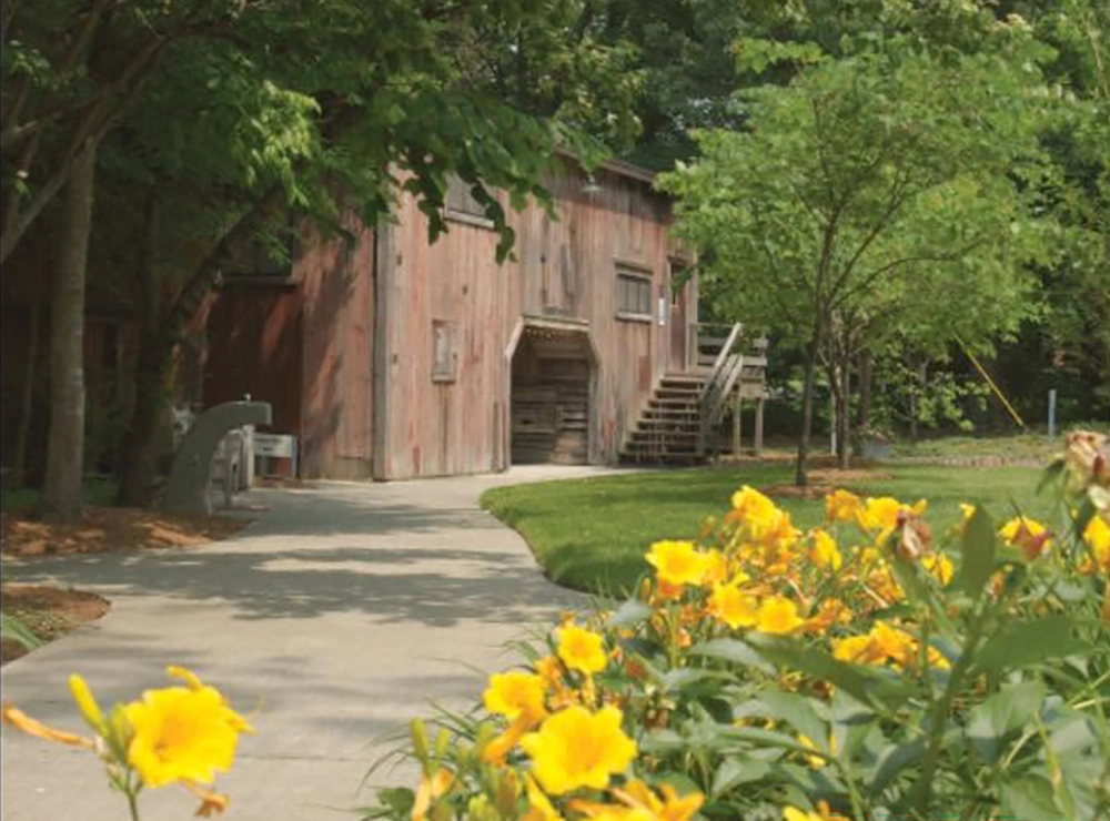 Hemingway Studio Barn with yellow flowers outside.