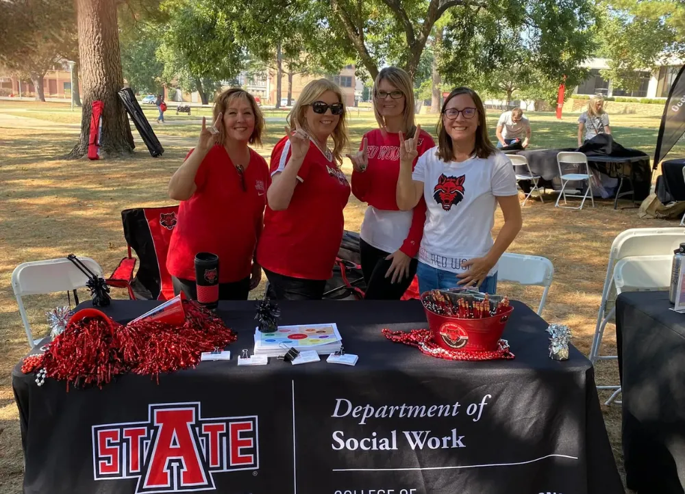 Social worker department at an event outside on campus with their departments tent up.