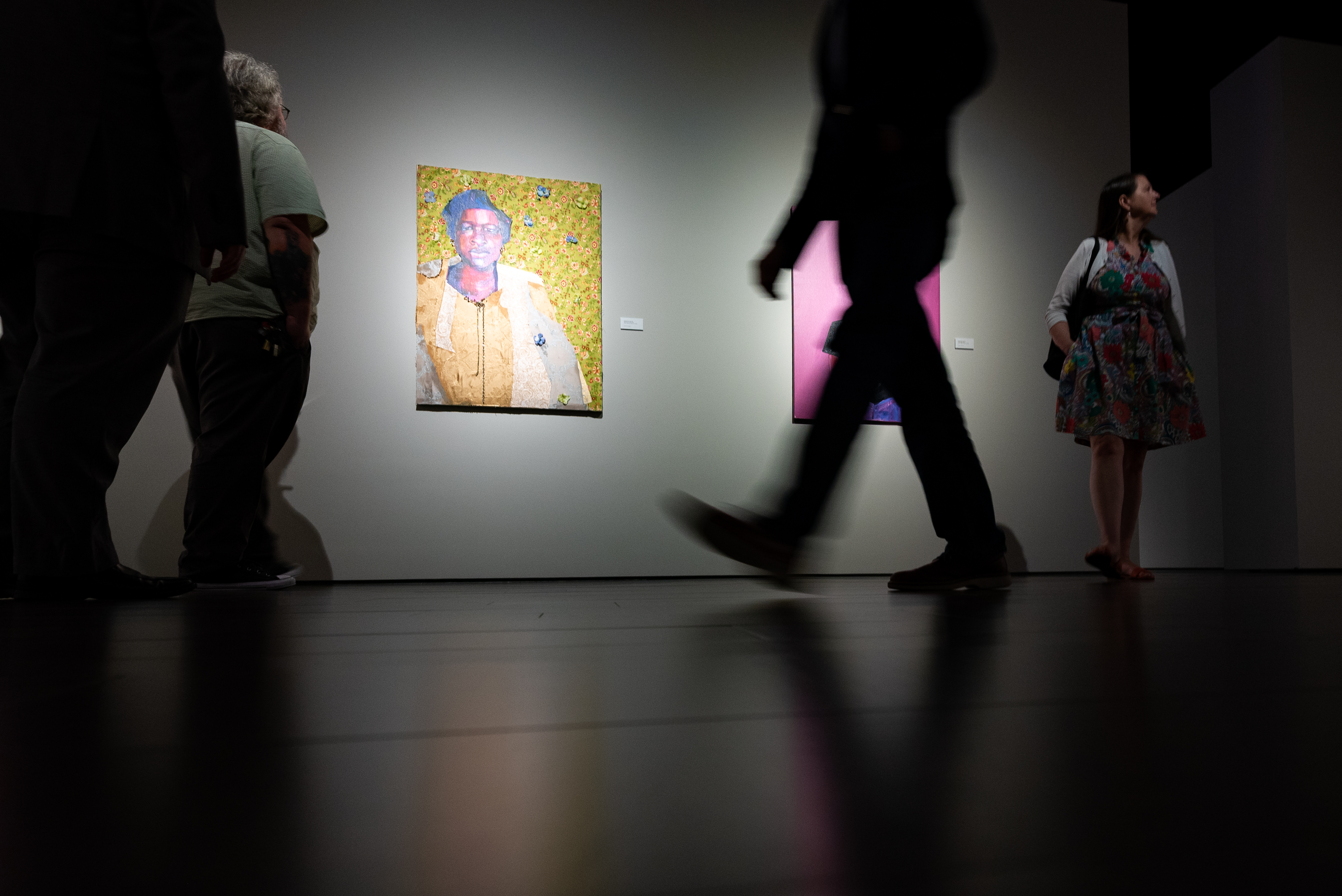 A low-angle picture of people walking through the Bradbury Art Museum.