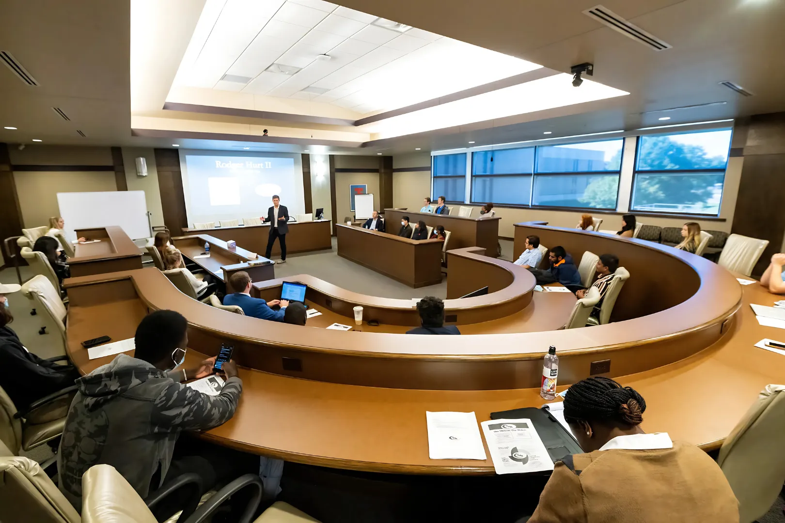 business class listening to Robert Hurt give lecture.