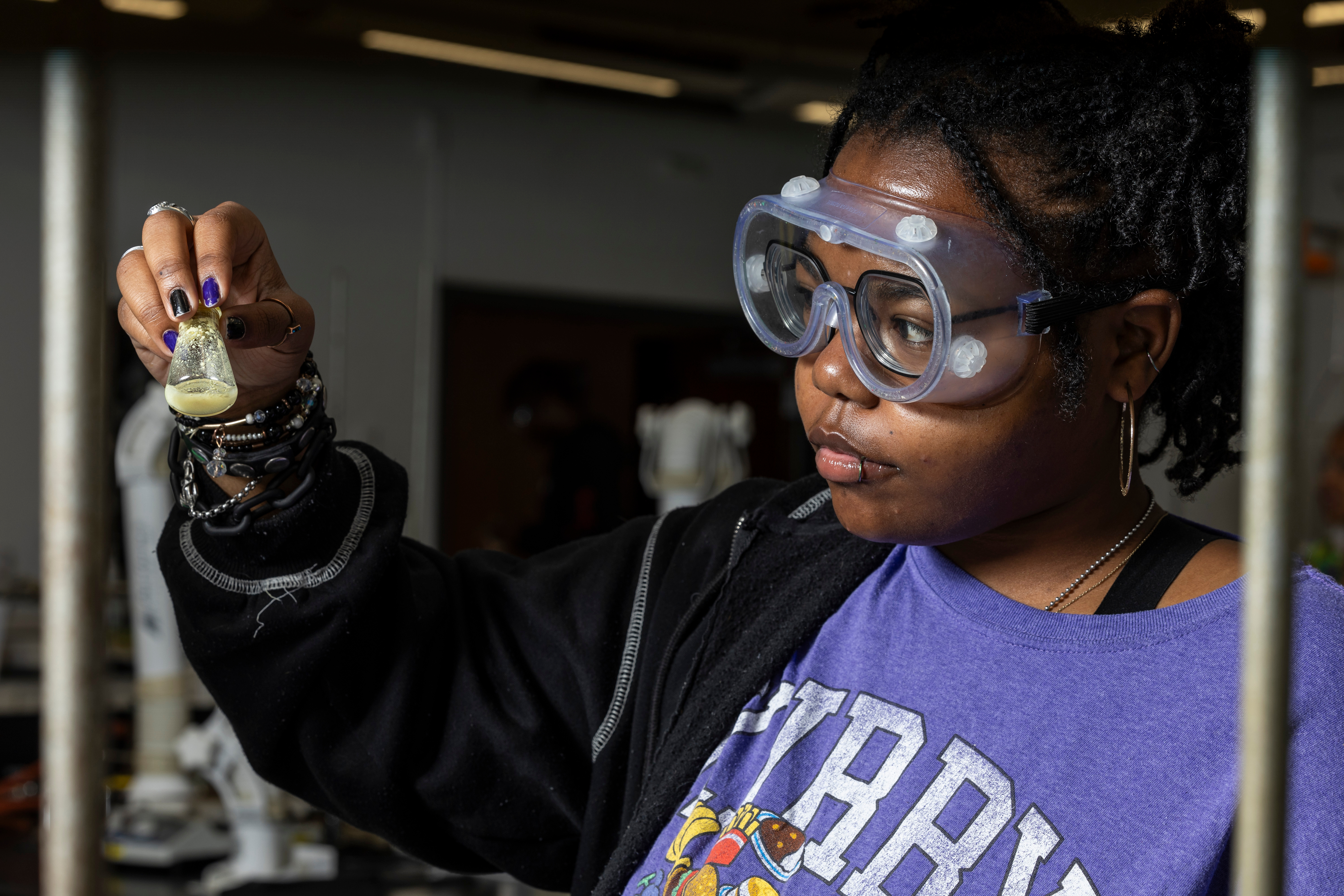 A student examining a vial during a lab.
