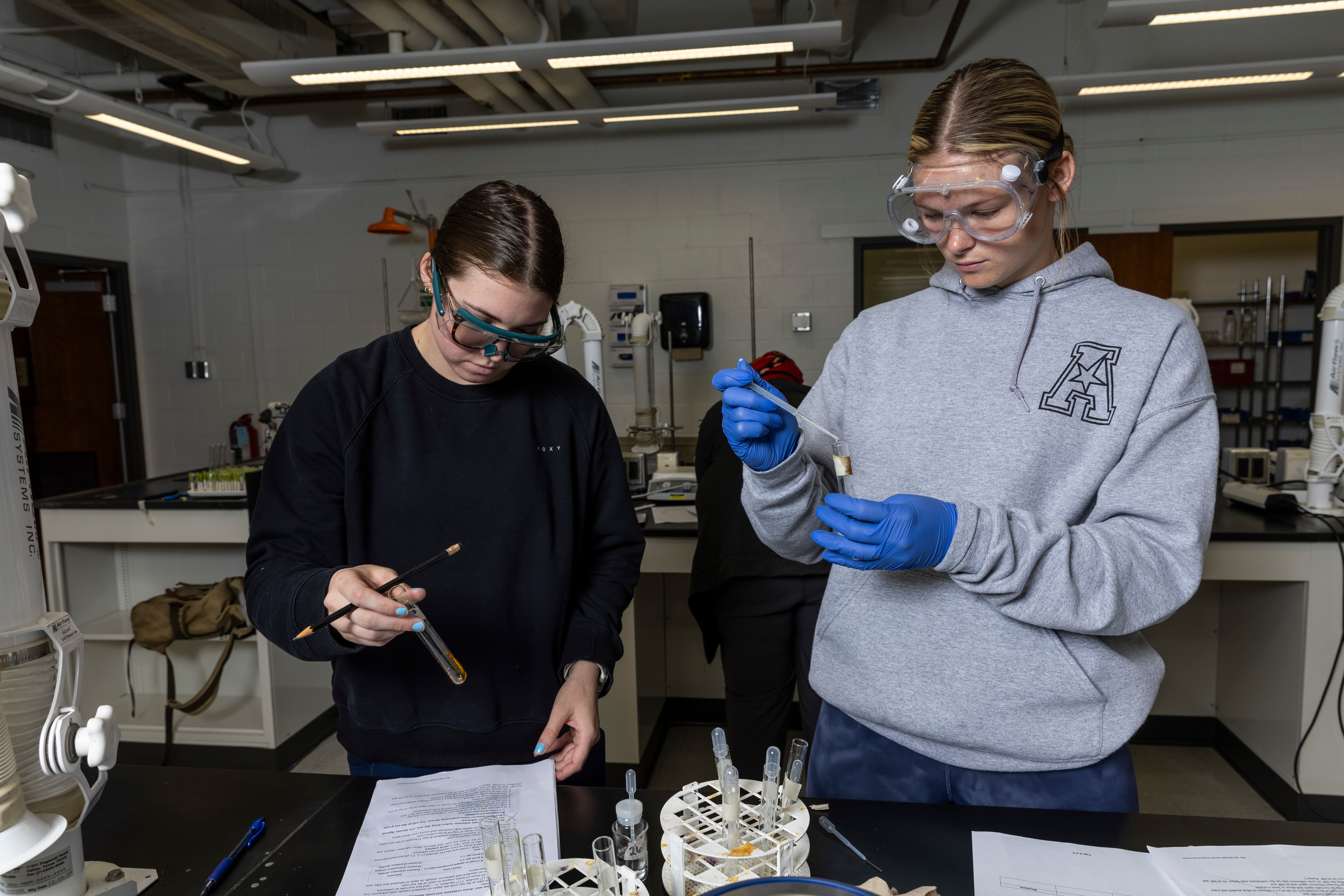 Two students performing an experiment.