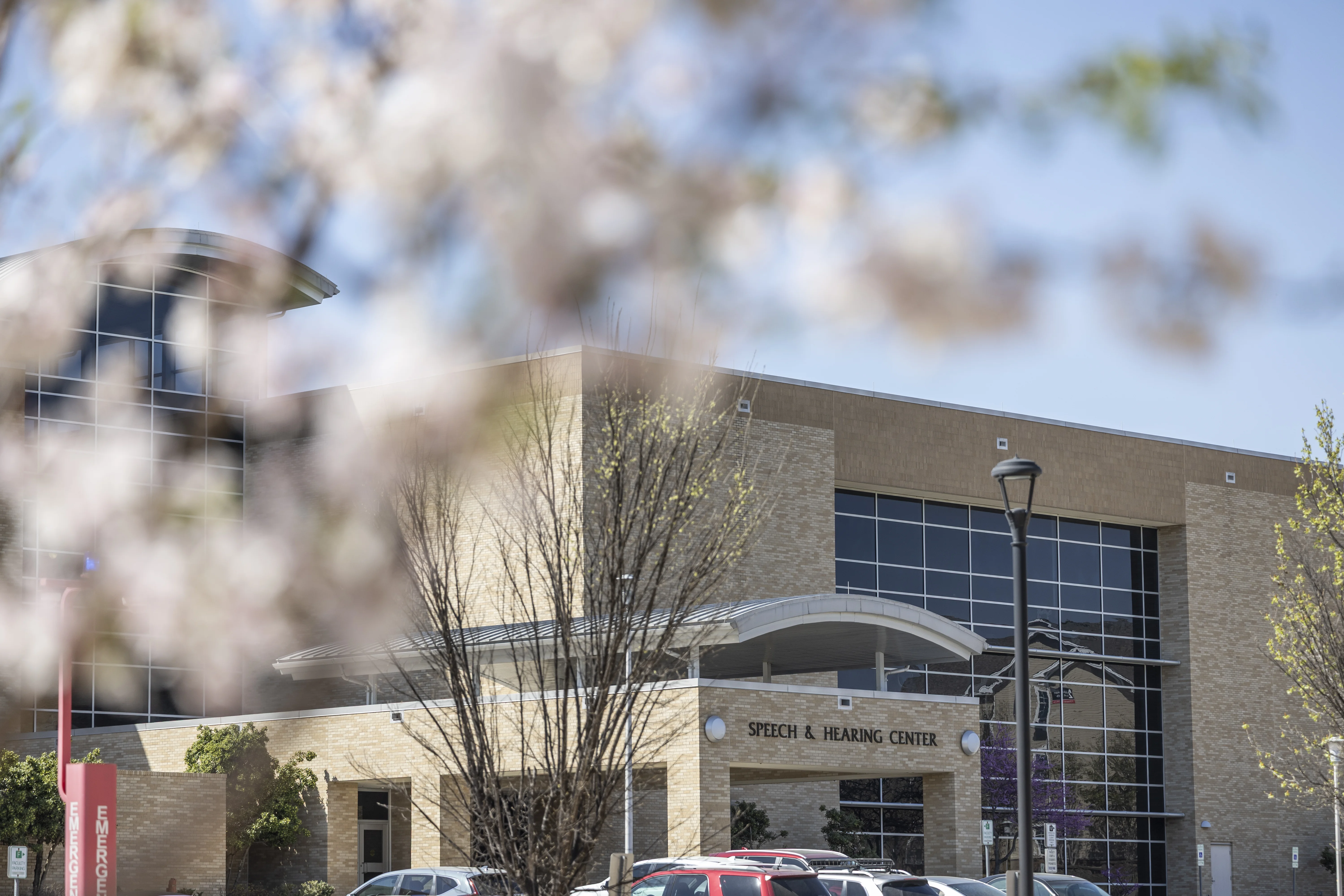 Speech and hearing center on campus with flowers in the foreground.