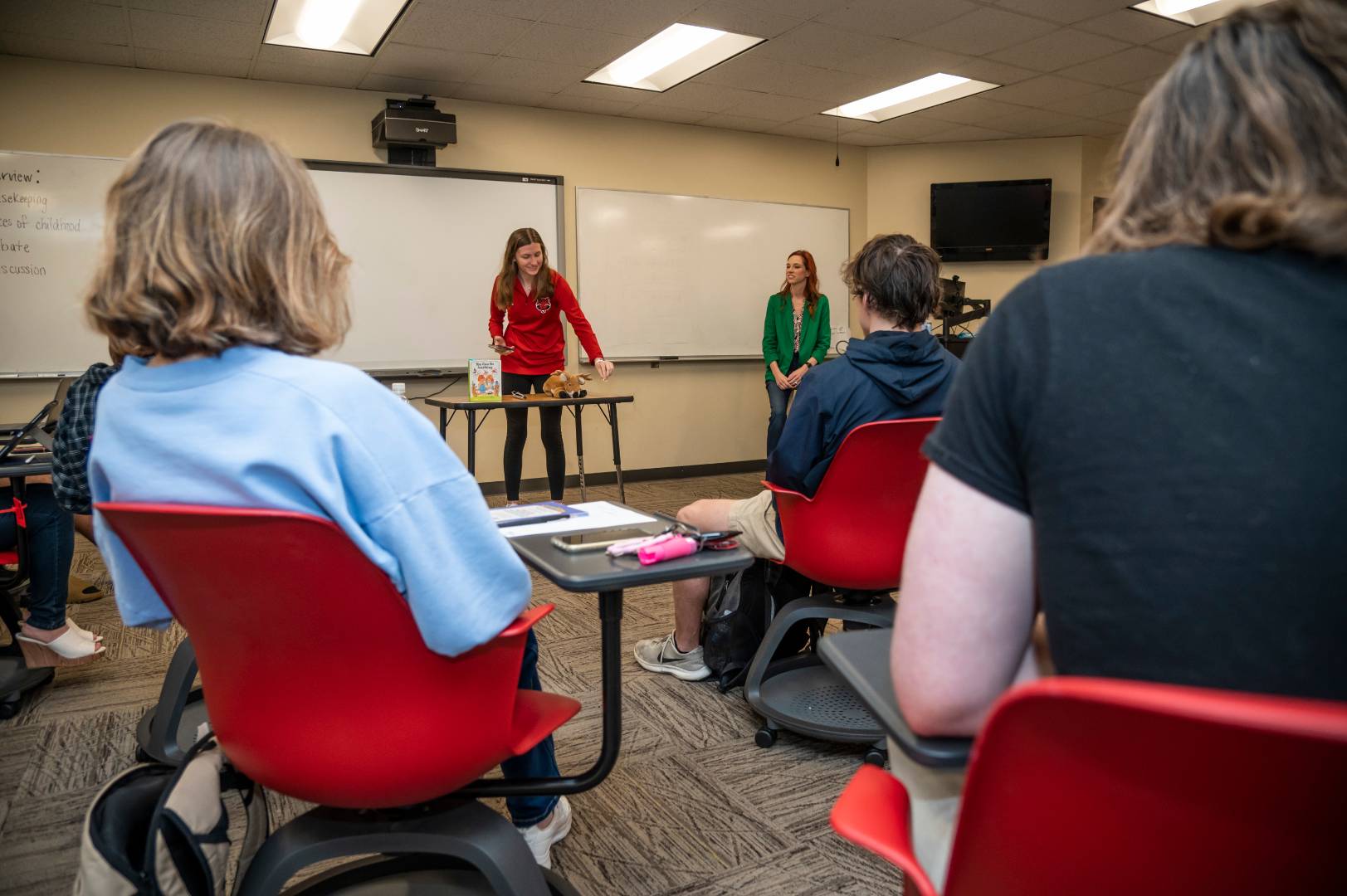 A student giving a presentation in front of the class.