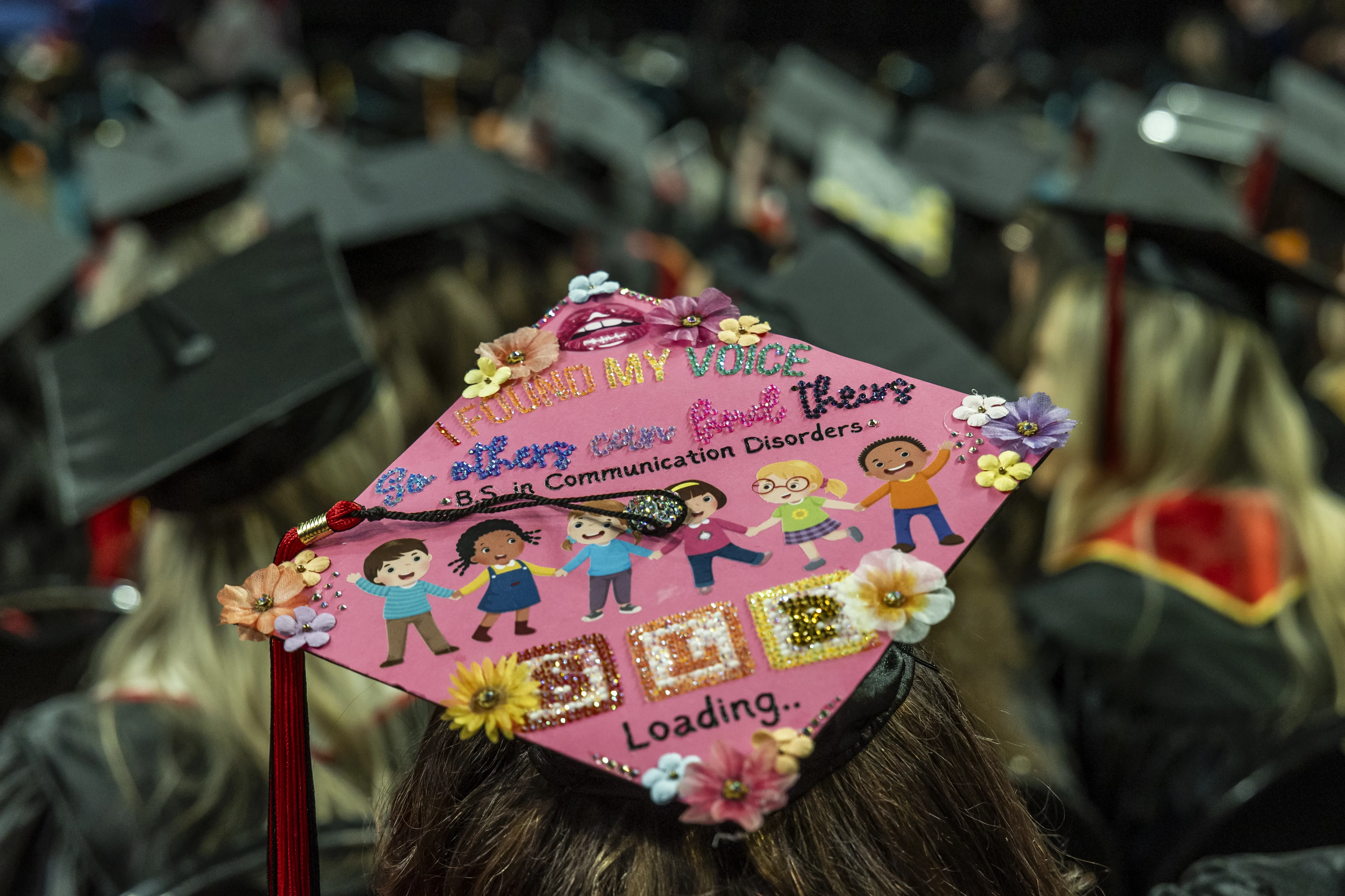 Communication Disorders graduate with decorated cap that says I found my voice so others can find theirs