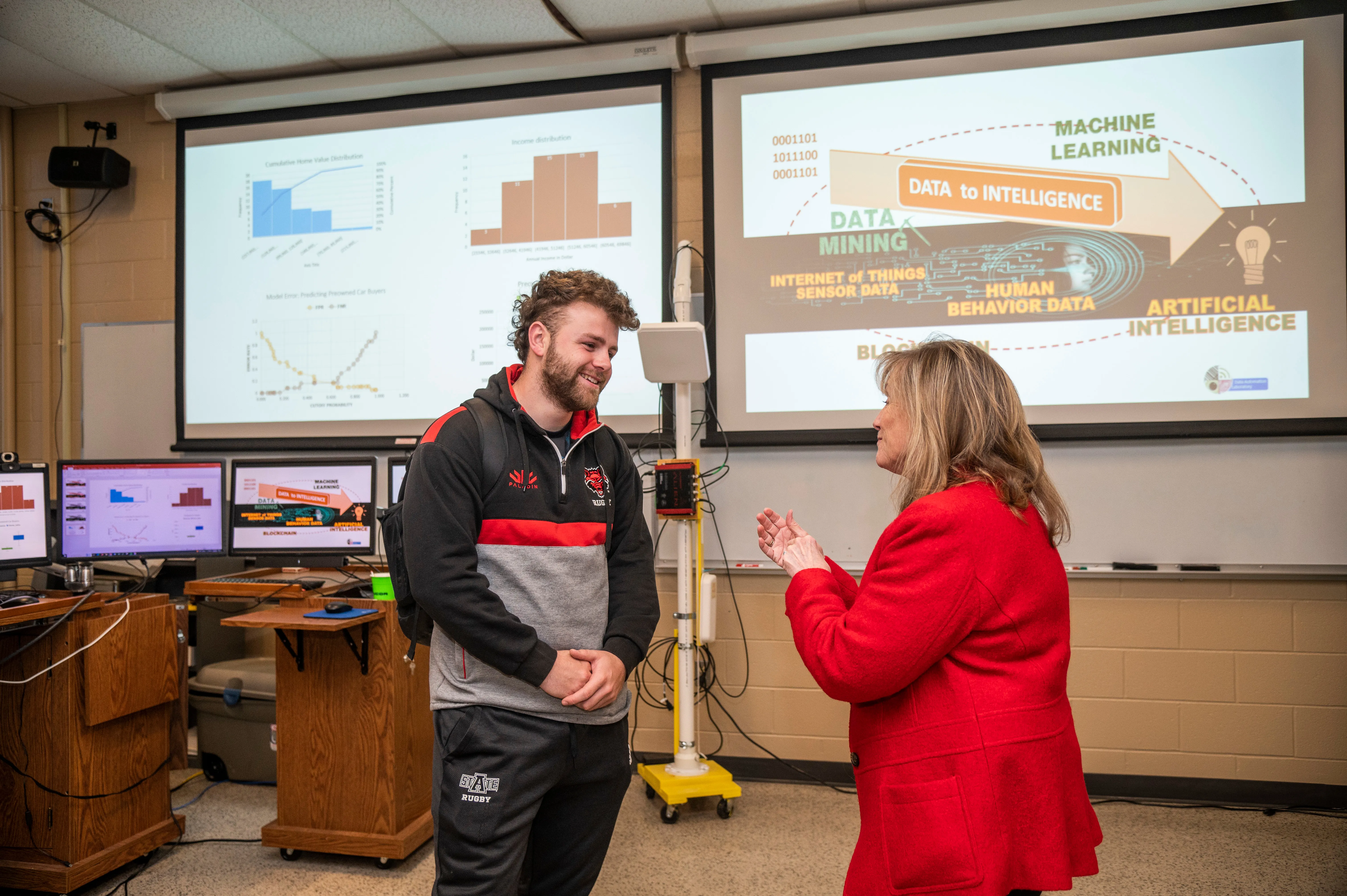 Computer Science student working on machine learning in class with professor.