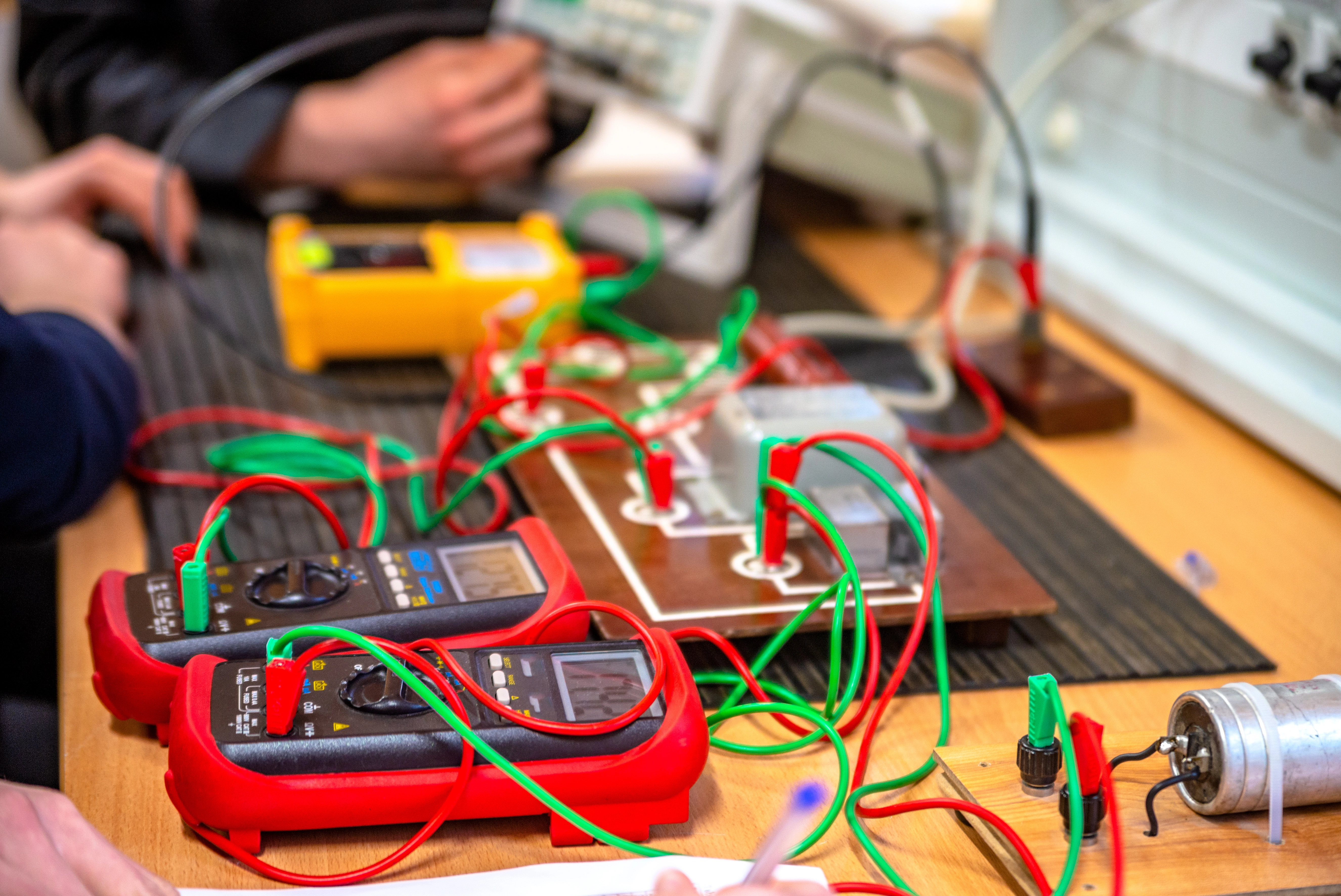 Engineering student using voltmeters in class.