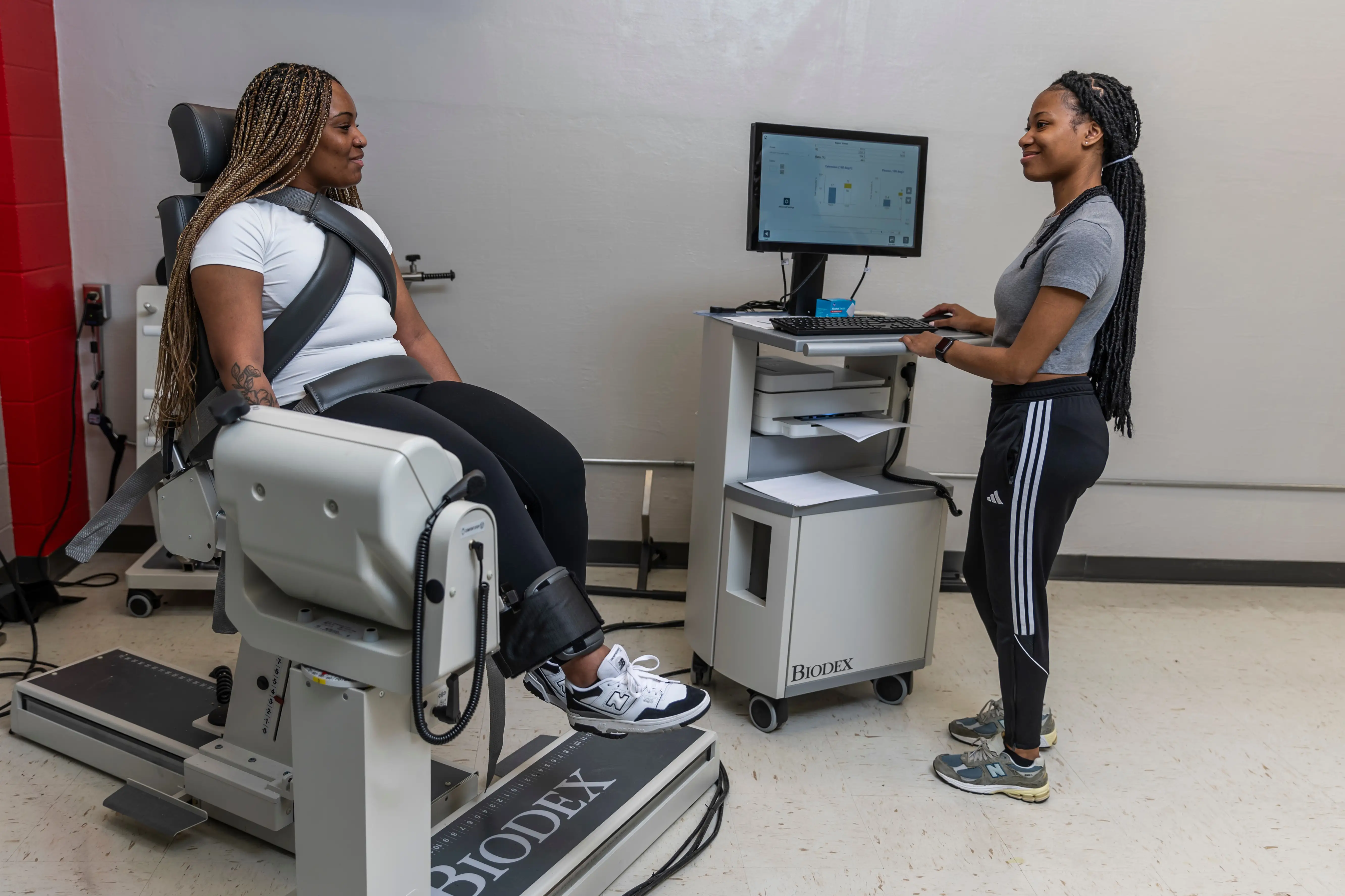 Two students performing research in the Human Performance Lab.