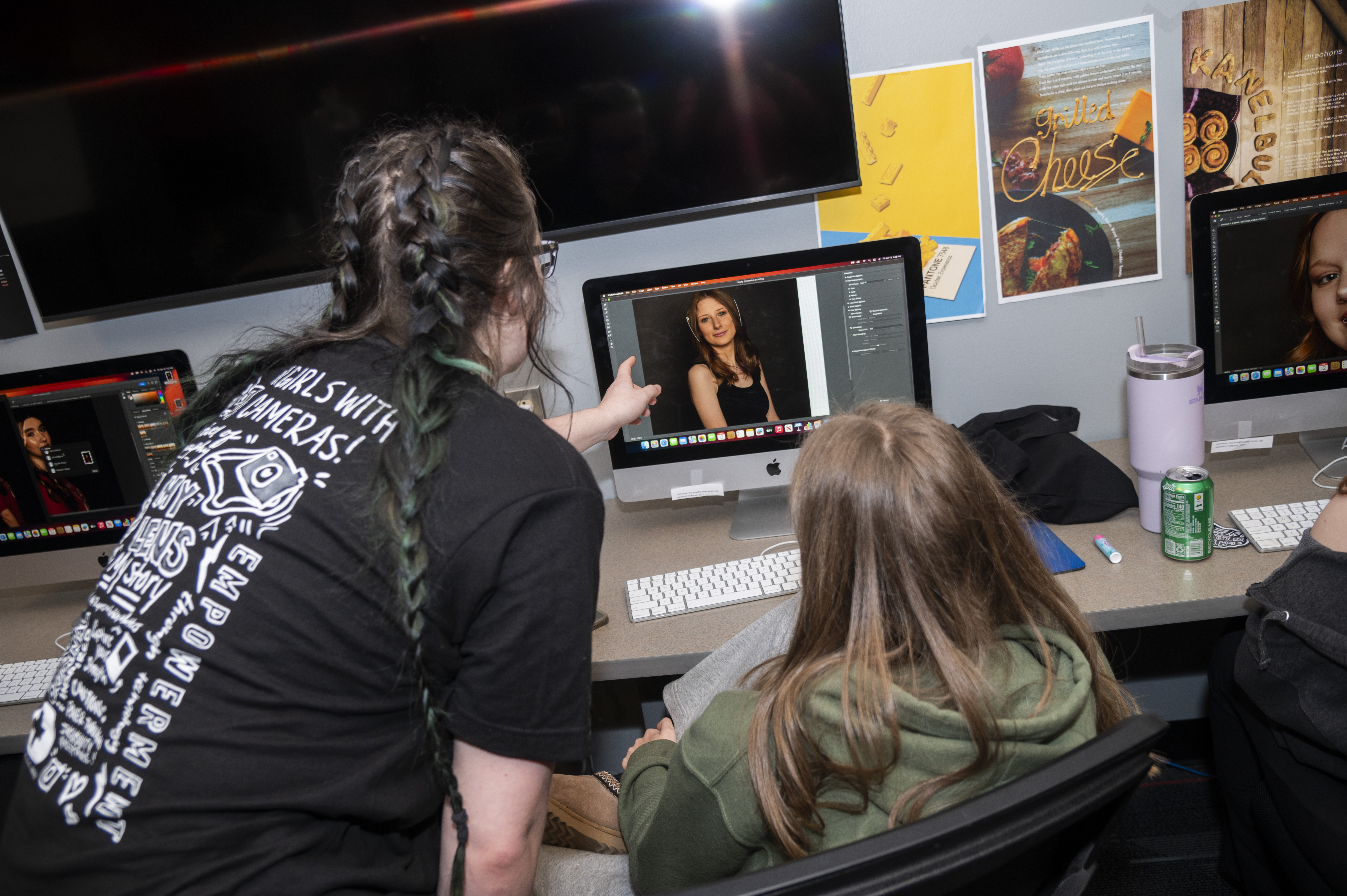 Two students using Photoshop for a project.