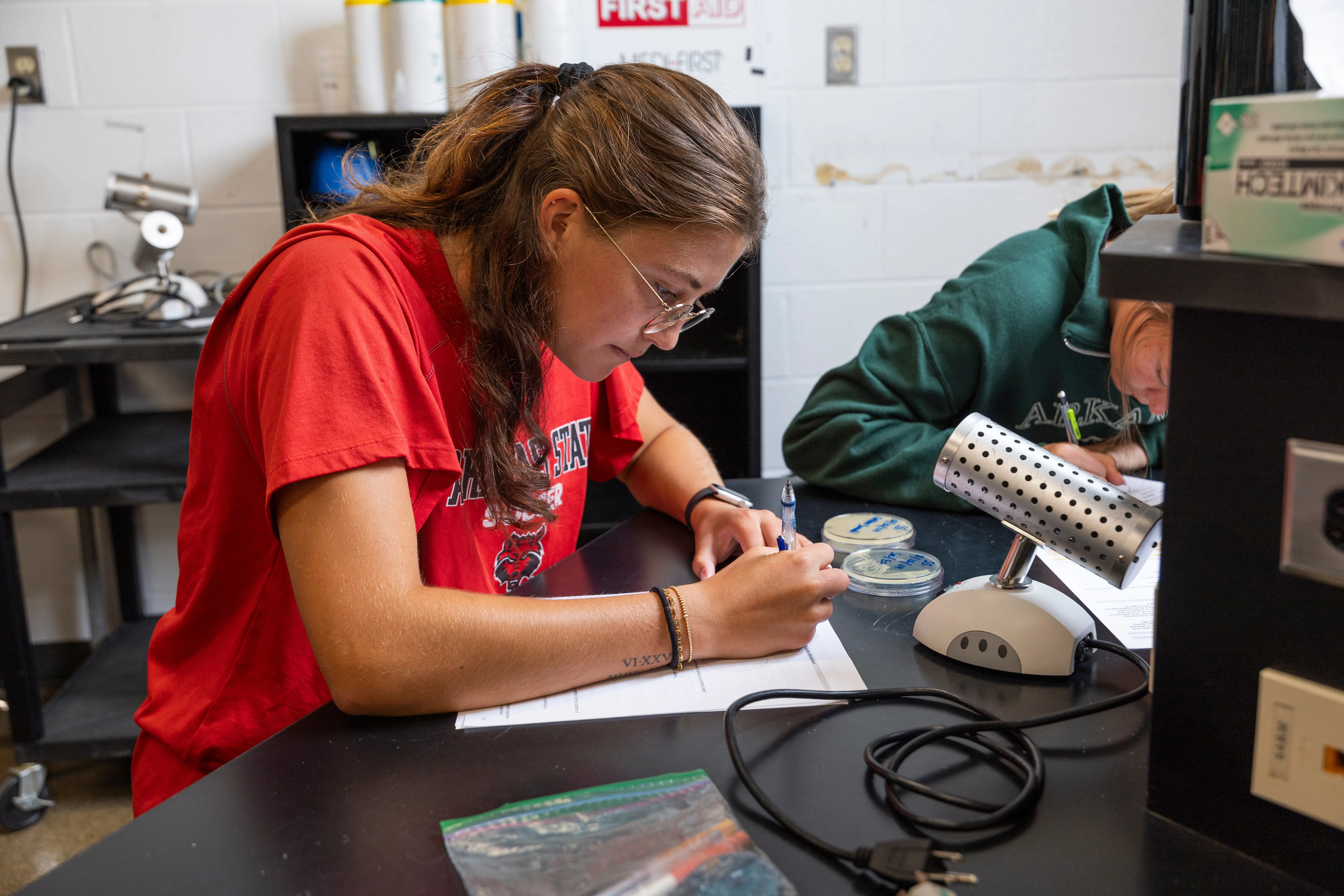 A student checking the other's blood pressure during a lab.