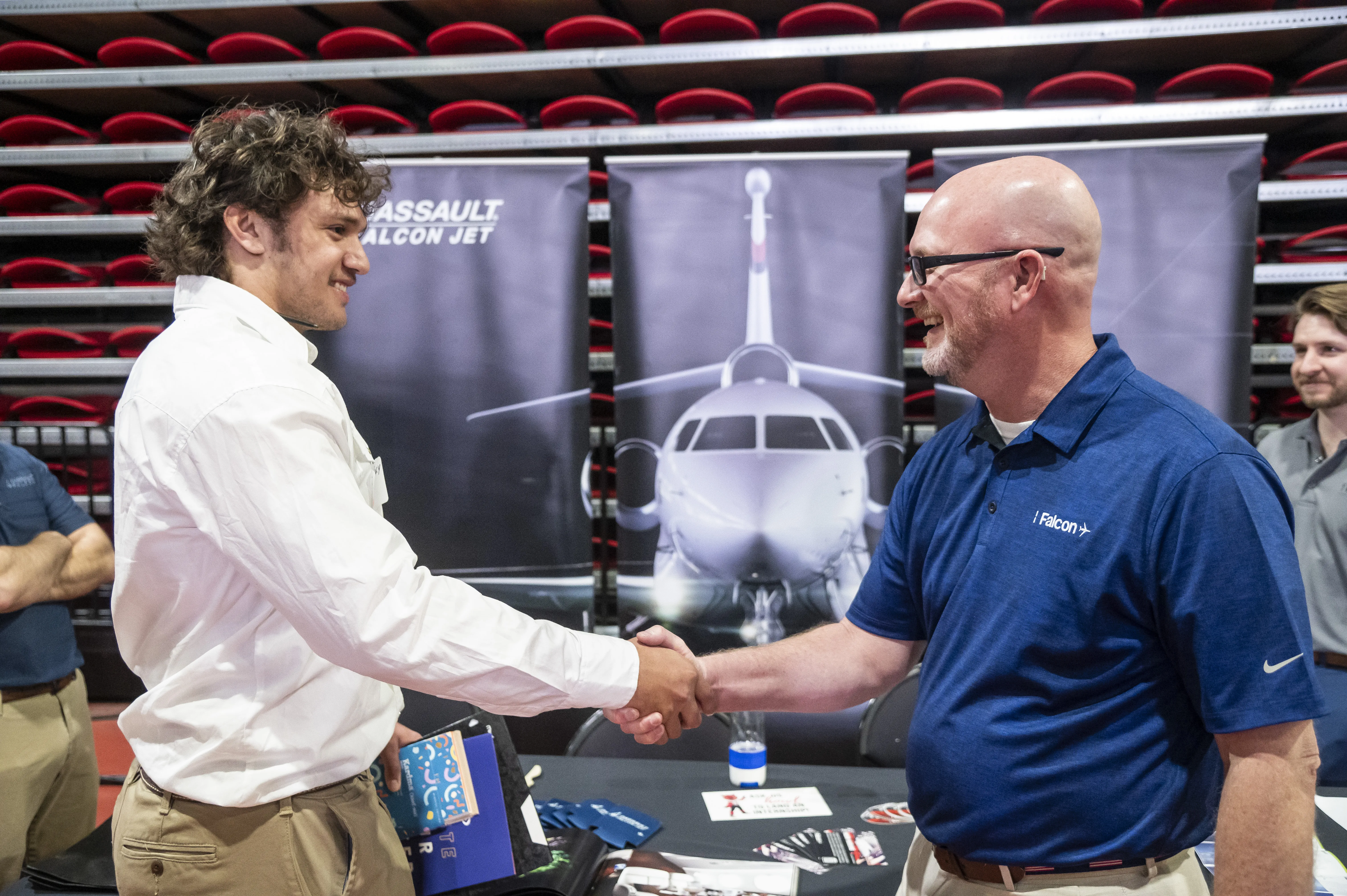 A-State student at job fair shaking hands with future boss.