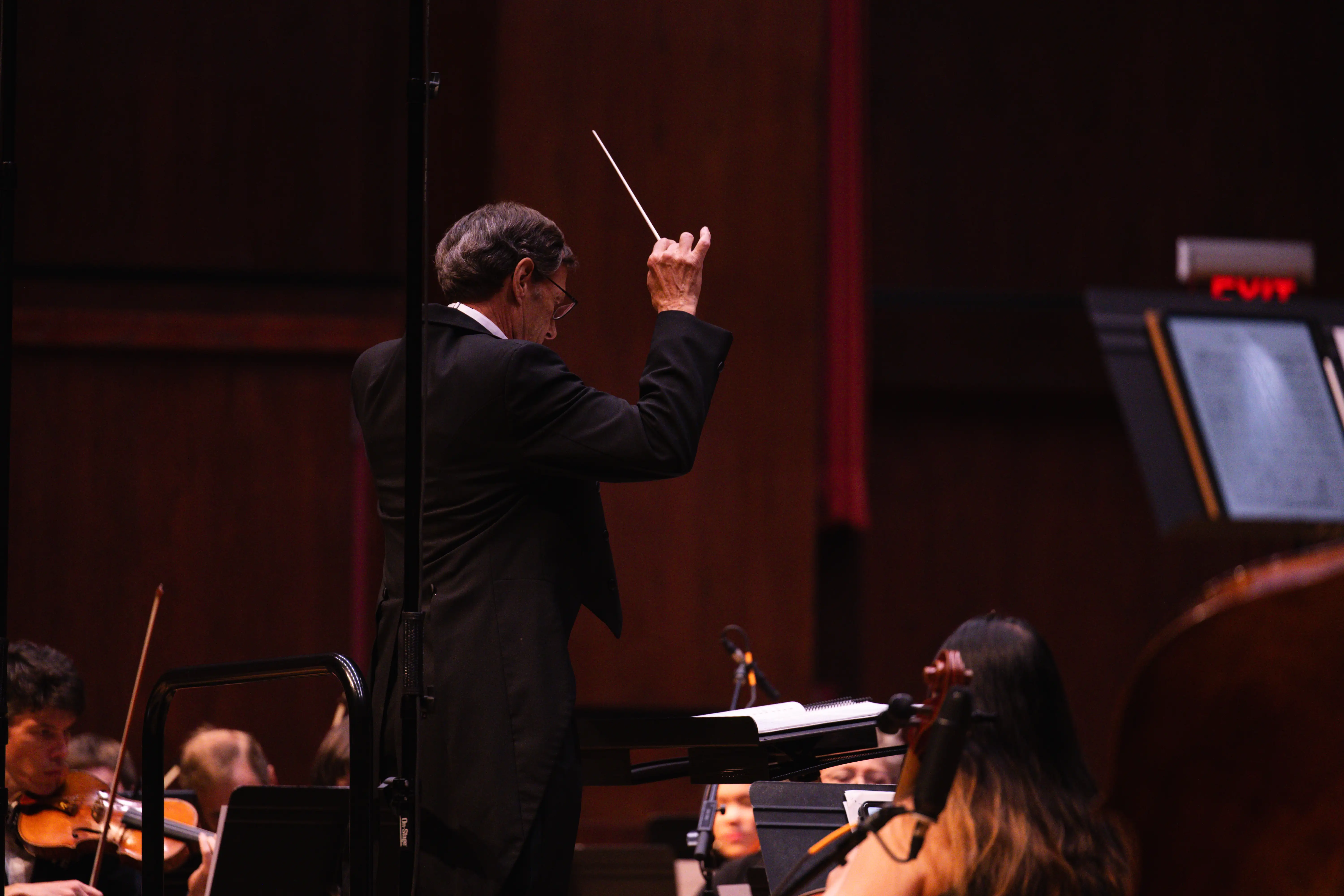 A conductor directing an orchestra.