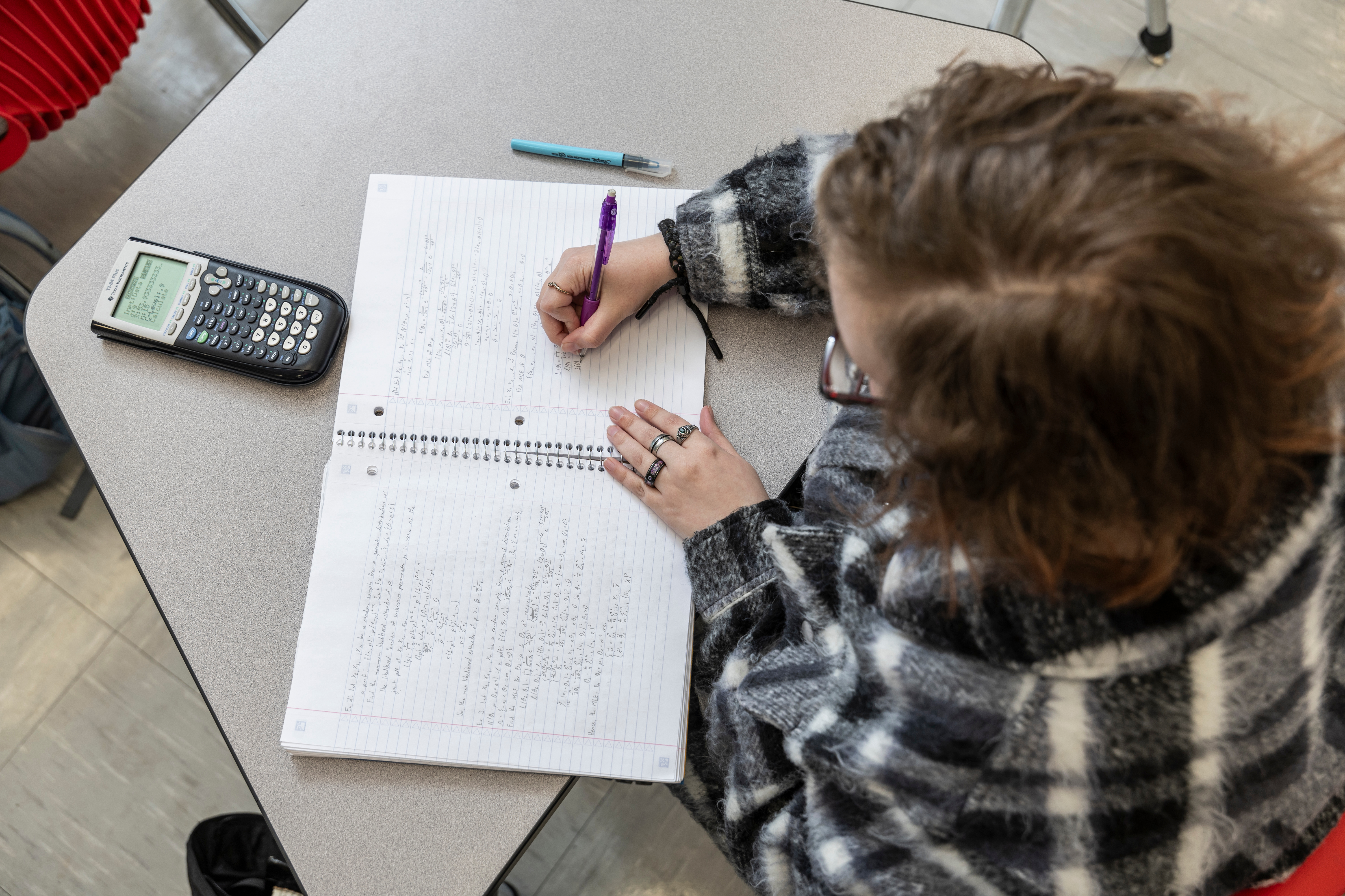 A top-down view of a student working on a math problem.